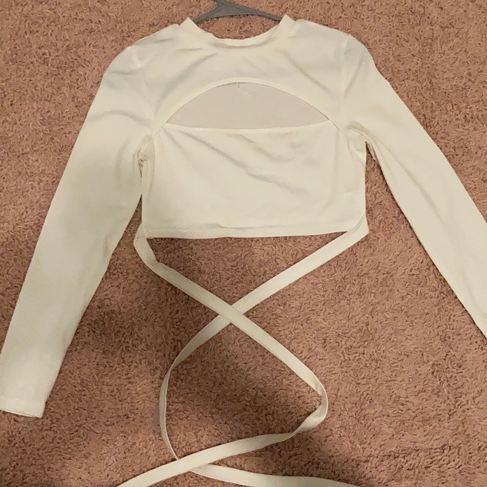 A tight white long sleeve crop top with ties !!